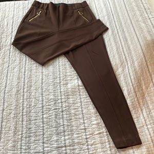 Brown slacks with gold zippered pockets. Stretchy material and tapered ankle